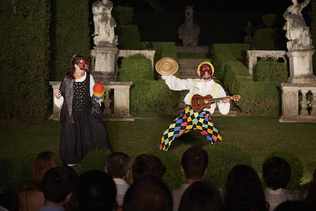 Commedia dell'Arte students performing in colorful costumes and masks